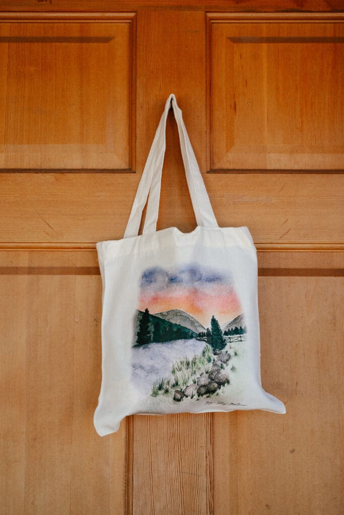 Custom illustrated Big Sky Montana tote bag included in wedding welcome boxes for guests at a 320 Ranch buyout wedding weekend