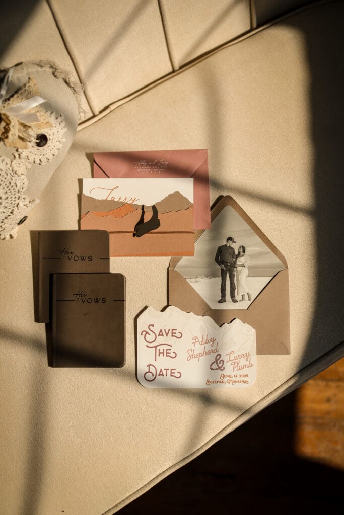 Bozeman Montana wedding stationery featuring custom mountain inspired save the date, leather vow books, and western wedding design details.

