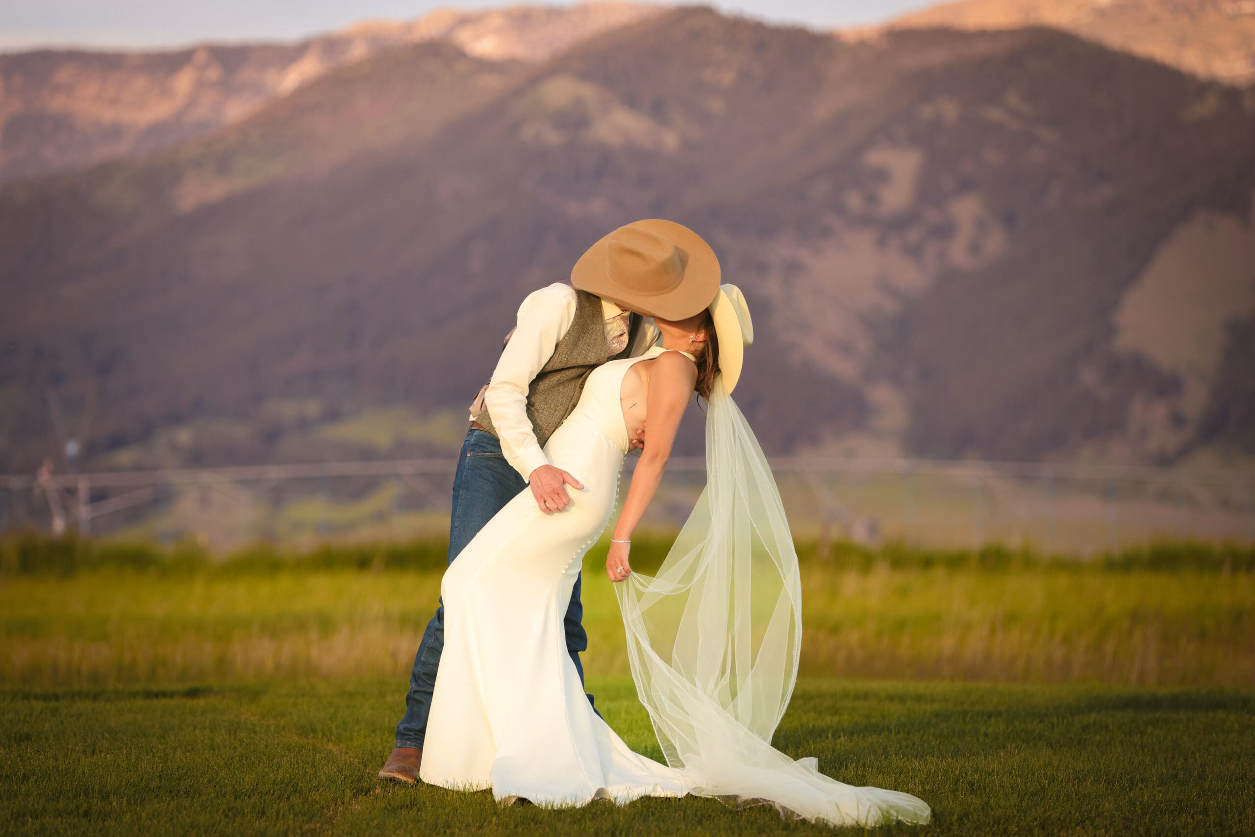 Bride and groom at Bozeman Montana destination wedding with mountain backdrop at golden hour