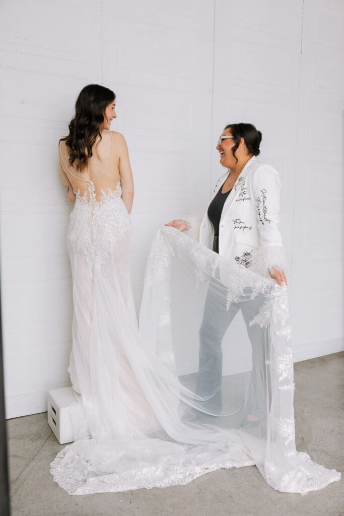 Luxury wedding planner in Bozeman helping bride during couture dress fitting