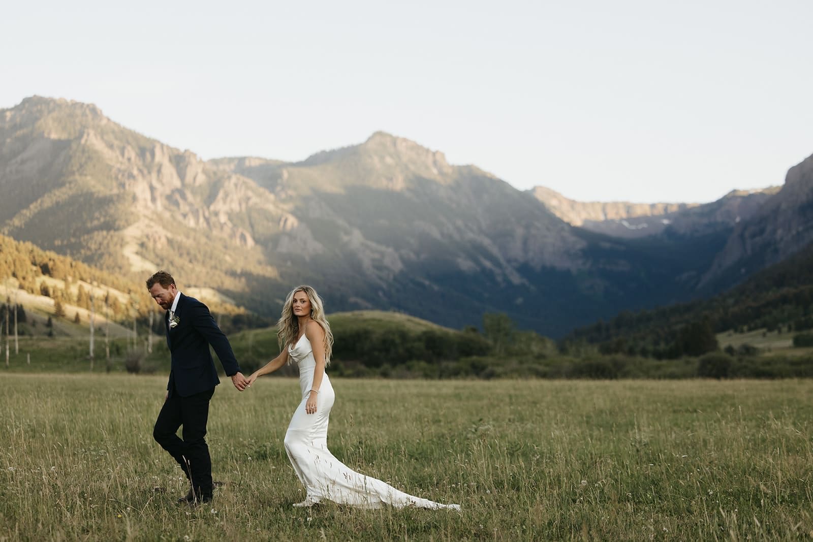 Wedding couple walking through valley in Montana